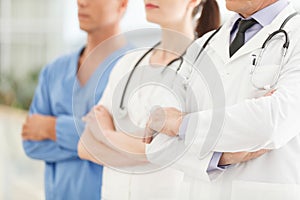 Only professional medical assistance. Cropped image of successful doctors team standing together with their arms crossed