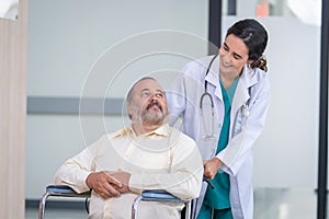 Professional Medical Doctor diagnosing and giving advice to the elderly patient at hospital