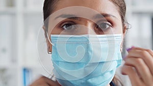 Professional medical doctor in hospital office, Portrait of young and attractive female physician in protective mask.