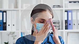 Professional medical doctor in hospital office, Portrait of young and attractive female physician in protective mask.