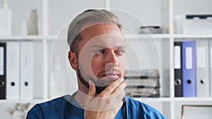 Professional medical doctor in hospital office, Portrait of young and confident physician.