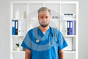 Professional medical doctor in hospital office, Portrait of young and confident physician.