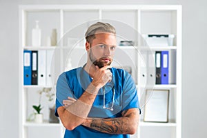 Professional medical doctor in hospital office, Portrait of young and confident physician.