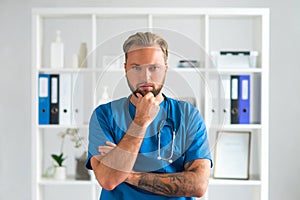 Professional medical doctor in hospital office, Portrait of young and confident physician.