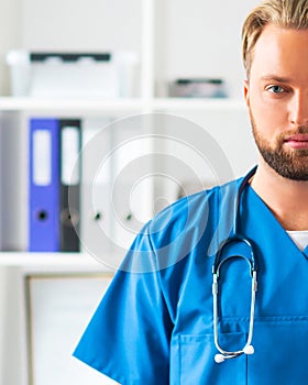 Professional medical doctor in hospital office, Portrait of young and confident physician.