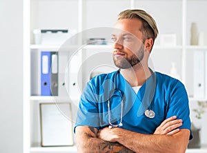 Professional medical doctor in hospital office, Portrait of young and confident physician.