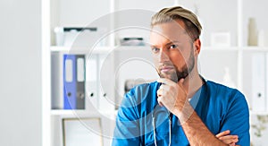 Professional medical doctor in hospital office, Portrait of young and confident physician.