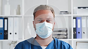 Professional medical doctor in hospital office, Portrait of young and confident physician in protective mask.