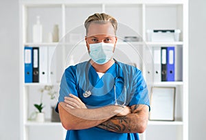 Professional medical doctor in hospital office, Portrait of young and confident physician in protective mask.