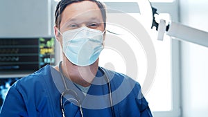Professional medical doctor working in emergency medicine. Portrait of the surgeon in protective mask.