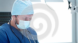 Professional medical doctor is working in emergency medicine. Portrait of the surgeon in protective mask performing