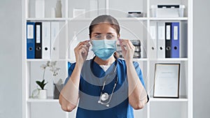 Professional medical doctor working in hospital office, Portrait of young and attractive female physician in protective