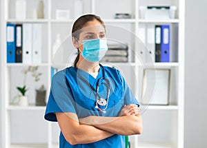 Professional medical doctor working in hospital office, Portrait of young and attractive female physician in protective