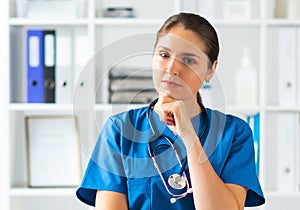 Professional medical doctor working in hospital office, Portrait of young and attractive female physician in protective