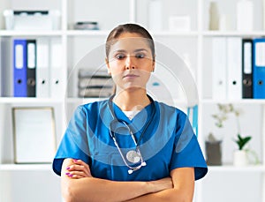 Professional medical doctor working in hospital office, Portrait of young and attractive female physician in protective