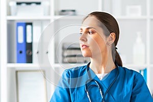 Professional medical doctor working in hospital office, Portrait of young and attractive female physician in protective