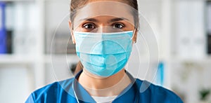 Professional medical doctor working in hospital office, Portrait of young and attractive female physician in protective