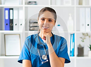 Professional medical doctor working in hospital office, Portrait of young and attractive female physician in protective