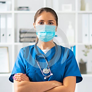 Professional medical doctor working in hospital office, Portrait of young and attractive female physician in protective