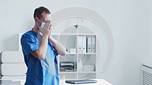 Professional medical doctor working in hospital office, Portrait of young and confident physician in protective mask.