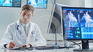 Professional medical doctor working in hospital office using computer technology. Medicine, cardiology and healthcare.