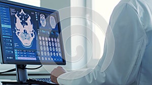 Professional medical doctor working in hospital office using computer technology. Medicine, neurosurgery and healthcare.