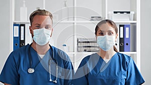 Professional medical doctors working in hospital office, Portrait of young and confident physicians in protective masks.