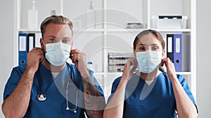 Professional medical doctors working in hospital office, Portrait of young and confident physicians in protective masks.