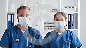 Professional medical doctors working in hospital office, Portrait of young and confident physicians in protective masks.