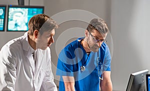 Professional medical doctors working in hospital office using computer technology. Medicine, neurosurgery and healthcare