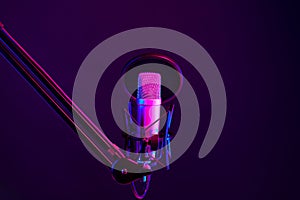 Professional microphone against black background in studio