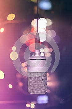 Professional microphone hanging on the cable, mic. Background de