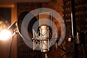 Professional microphone on stand in recording studio, closeup