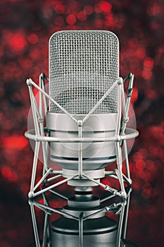 Professional microphone in unfocused background. Mic