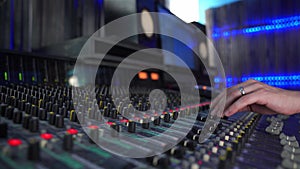 Professional mixing console in studio, sound control with LED backlight