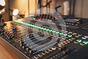 Professional mixing console on table in modern radio studio, closeup