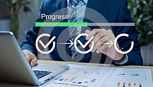 Businessman tracking project progress on a digital dashboard.