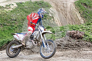 Professional Motocross Motorcycle Rider Drives Over the Road Track.