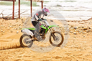 Professional Motocross Motorcycle Rider Drives Over the Road Track.