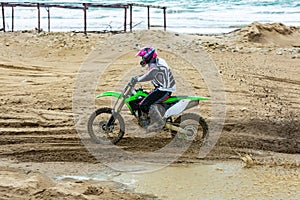 Professional Motocross Motorcycle Rider Drives Over the Road Track.