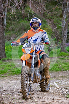 Professional Motocross Motorcycle Rider Drives Over the Road Track.