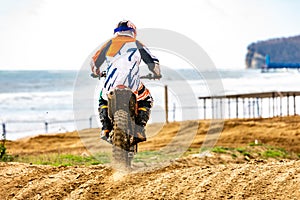 Professional Motocross Motorcycle Rider Drives Over the Road Track.