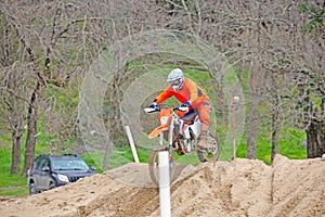 Professional Motocross Motorcycle Rider Drives Over the Road Track.