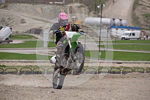 Professional Motocross Motorcycle Rider Drives Over the Road Track.