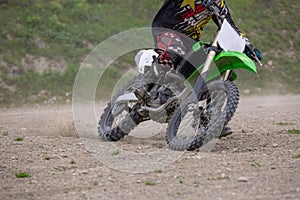 Professional Motocross Motorcycle Rider Drives Over the Road Track.