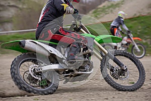 Professional Motocross Motorcycle Rider Drives Over the Road Track.