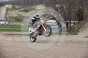 Professional Motocross Motorcycle Rider Drives Over the Road Track.