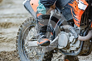 Professional Motocross Motorcycle Rider Drives Over the Road Track. Close up croped shot