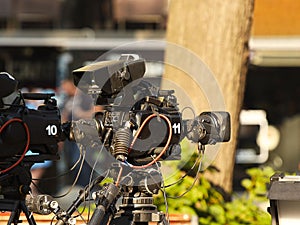 Professional movie cameras on the set among other equipment. Production of a film or report on the streets of the city