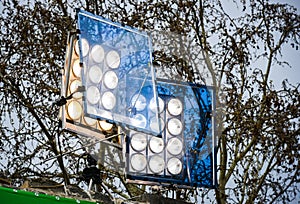 Professional movie light system with blue filter on outdoor set.